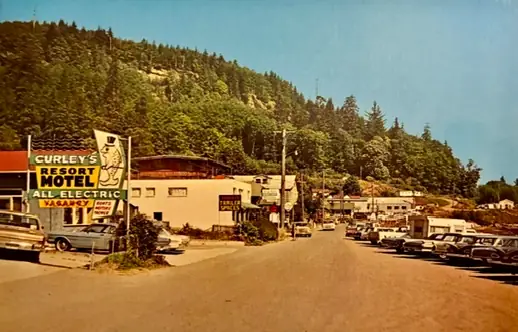 Vintage colour photo of Front Street with the Curley's Resort Motel All Electric sign