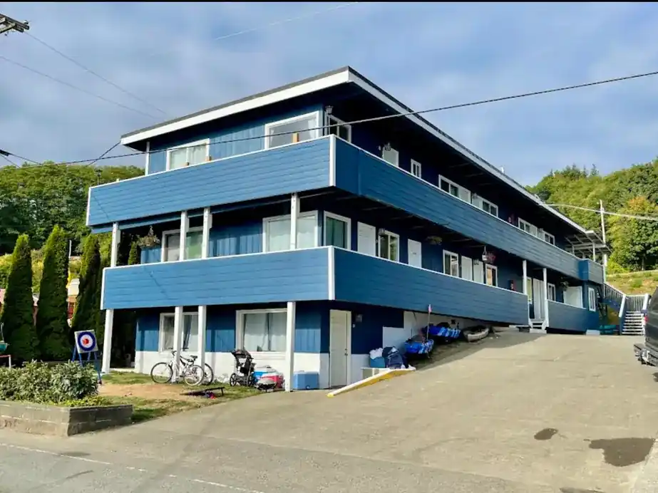 The blue three-storey Curley's motel building on Front Street with its white trim