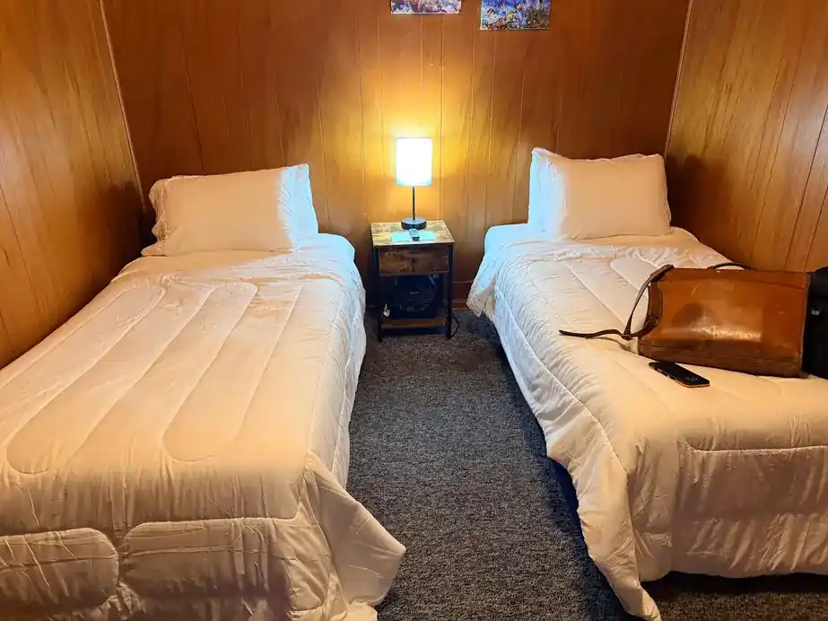 Twin beds in a wood-panelled bedroom of a first-floor unit