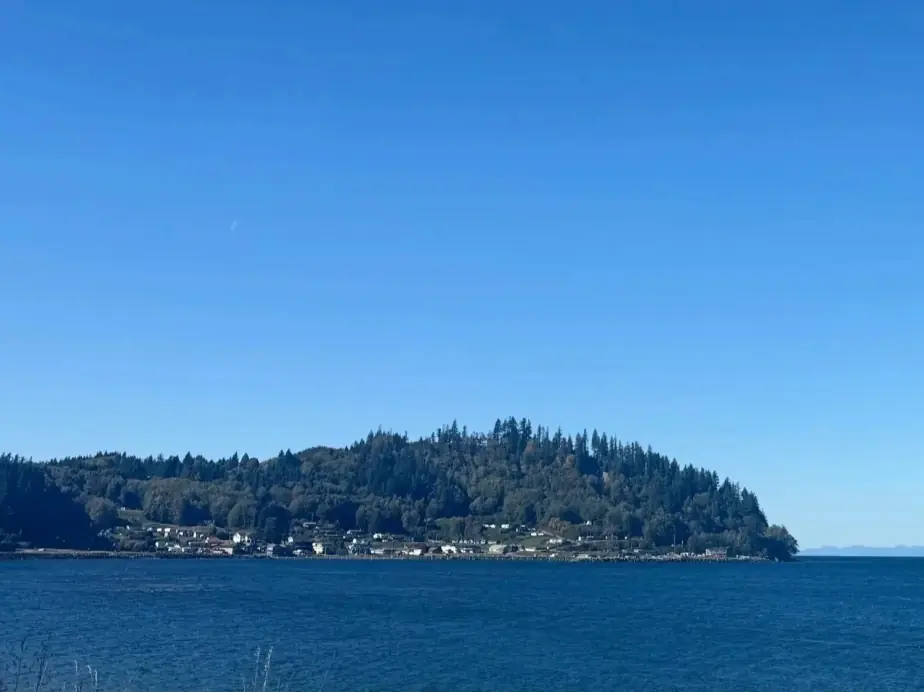 Sekiu Point across the Strait under a clear blue sky