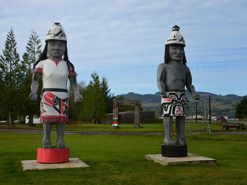 Carved Makah welcome figures standing in Neah Bay